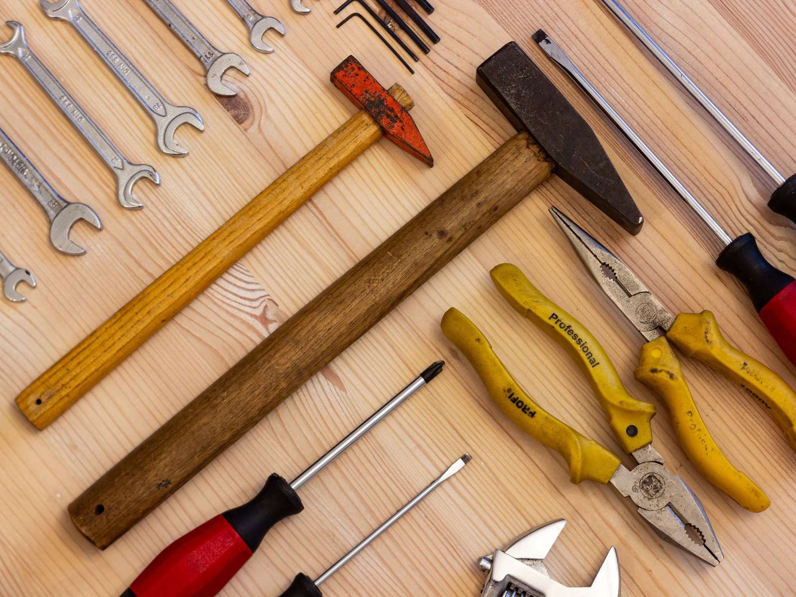 Hand tools laid out on a wooden bench
