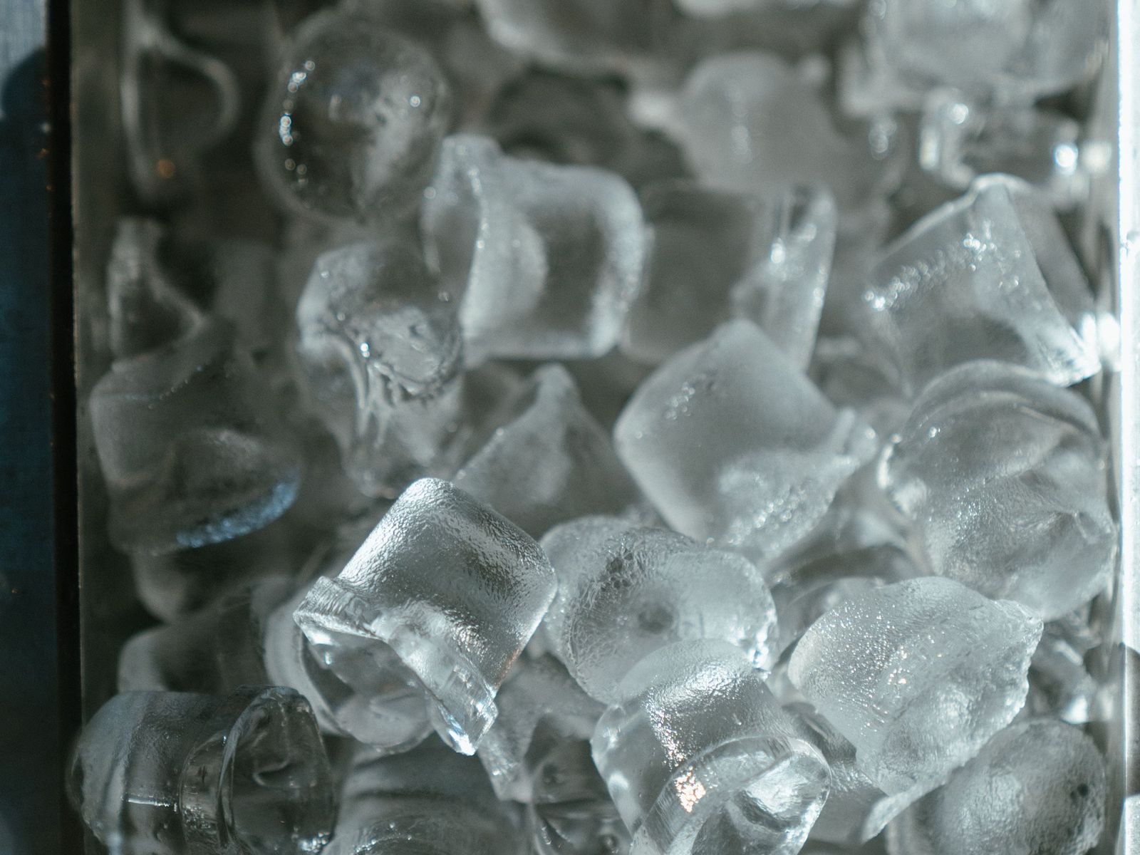 Fresh ice cubes in a stainless steel bin