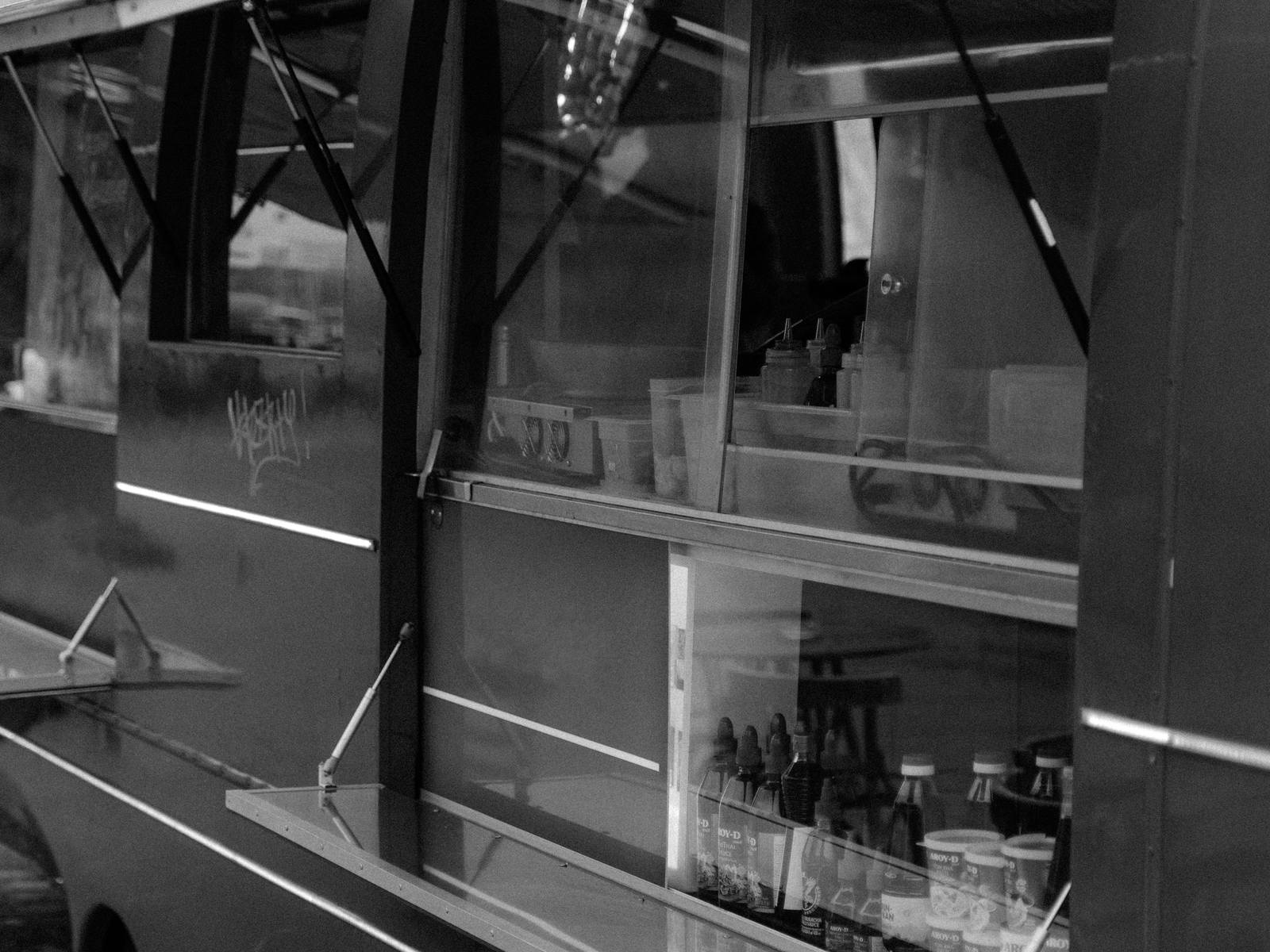 Side window of a food truck, black and white