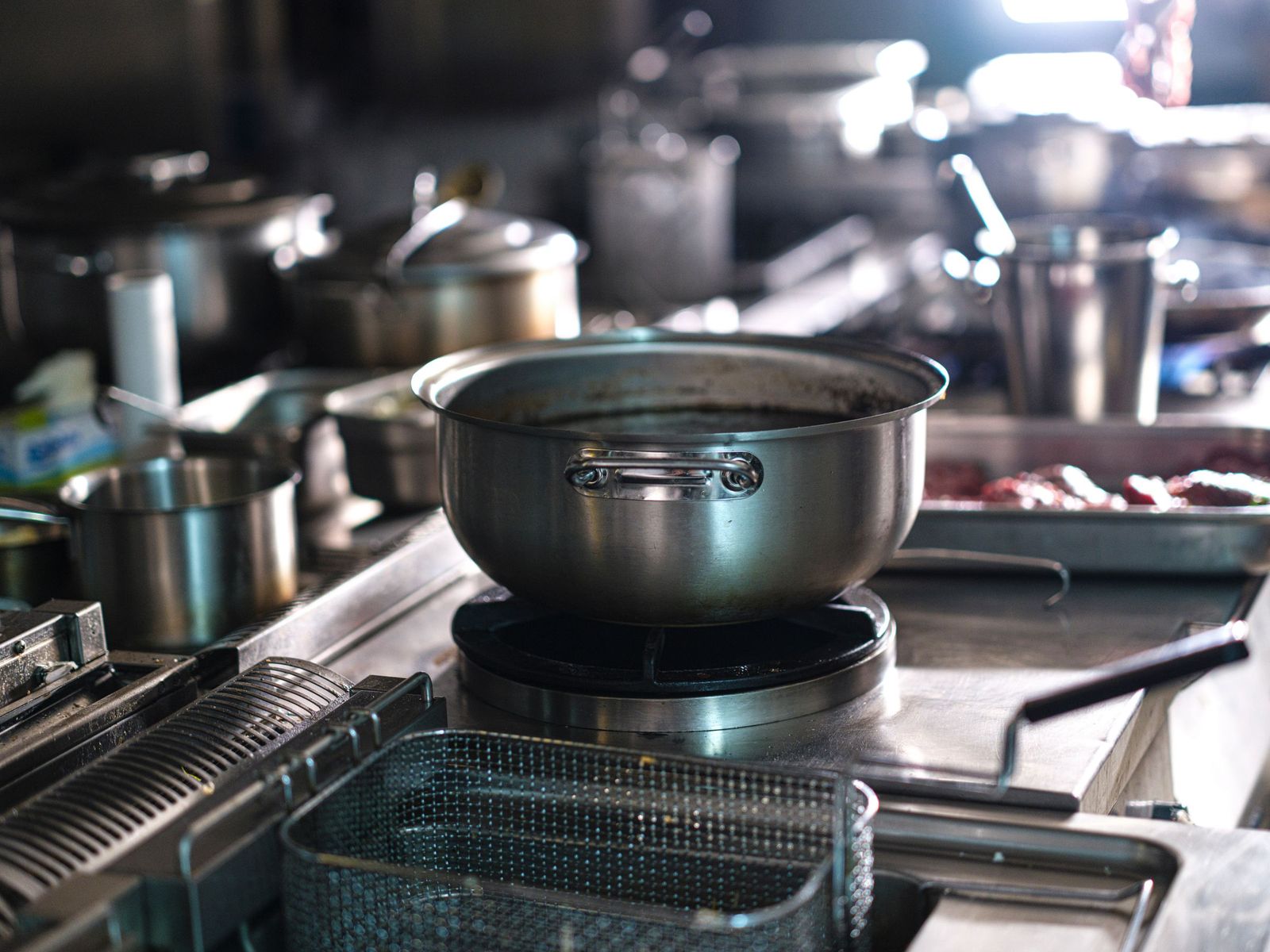 Stock pots on a commercial range in a working restaurant kitchen