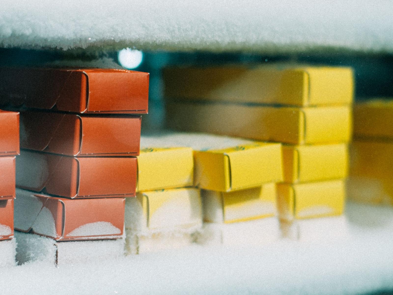 Frosted cases of product stacked inside a freezer